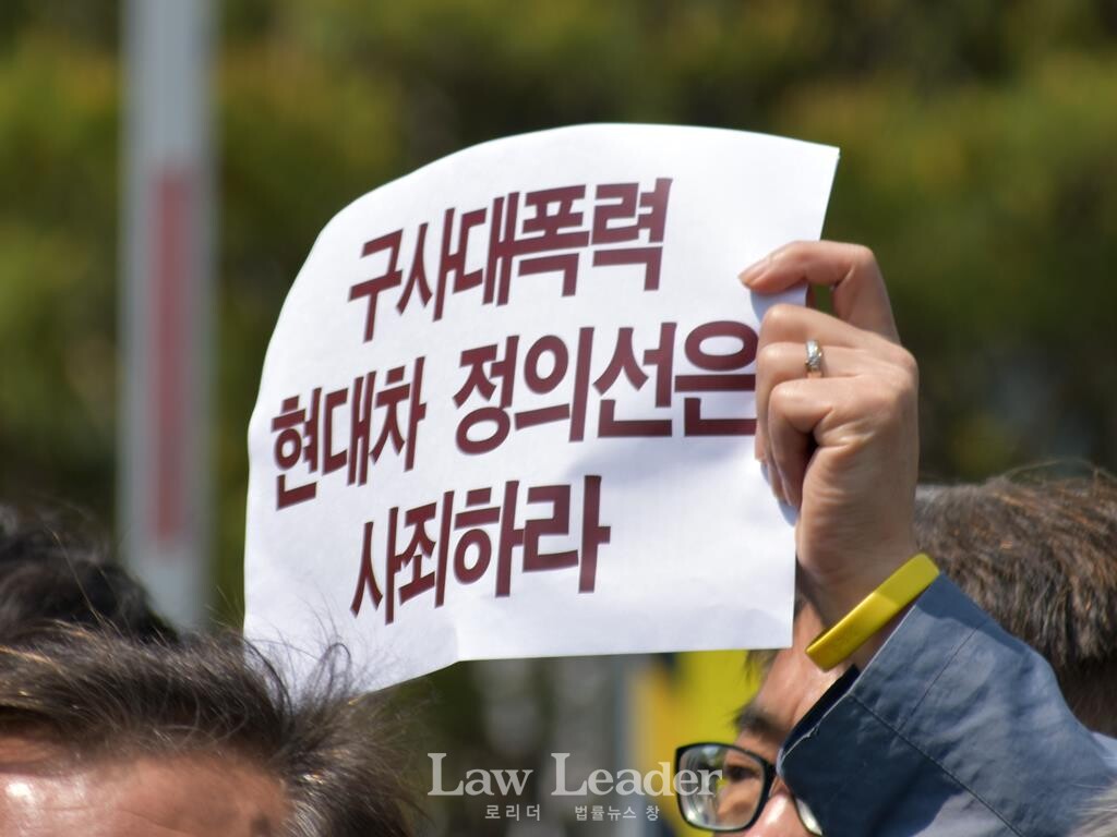 기자회견 참가자가 ‘구사대 폭력 현대차 정의선은 사죄하라’는 내용의 팻말을 들고 있다.